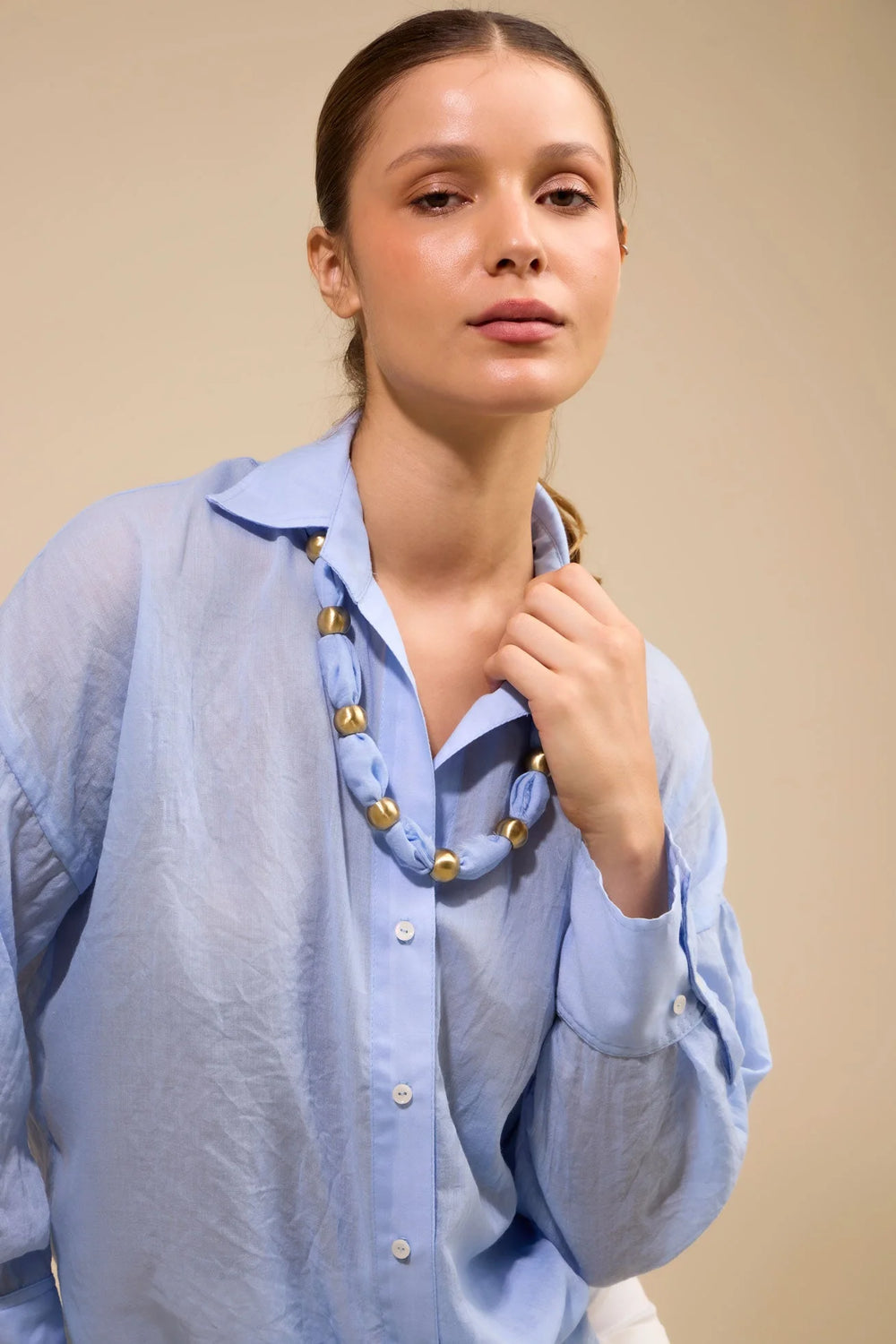 Collar Latido ANARIAS Atelier usado al cuello por fuera de camisa — look editorial